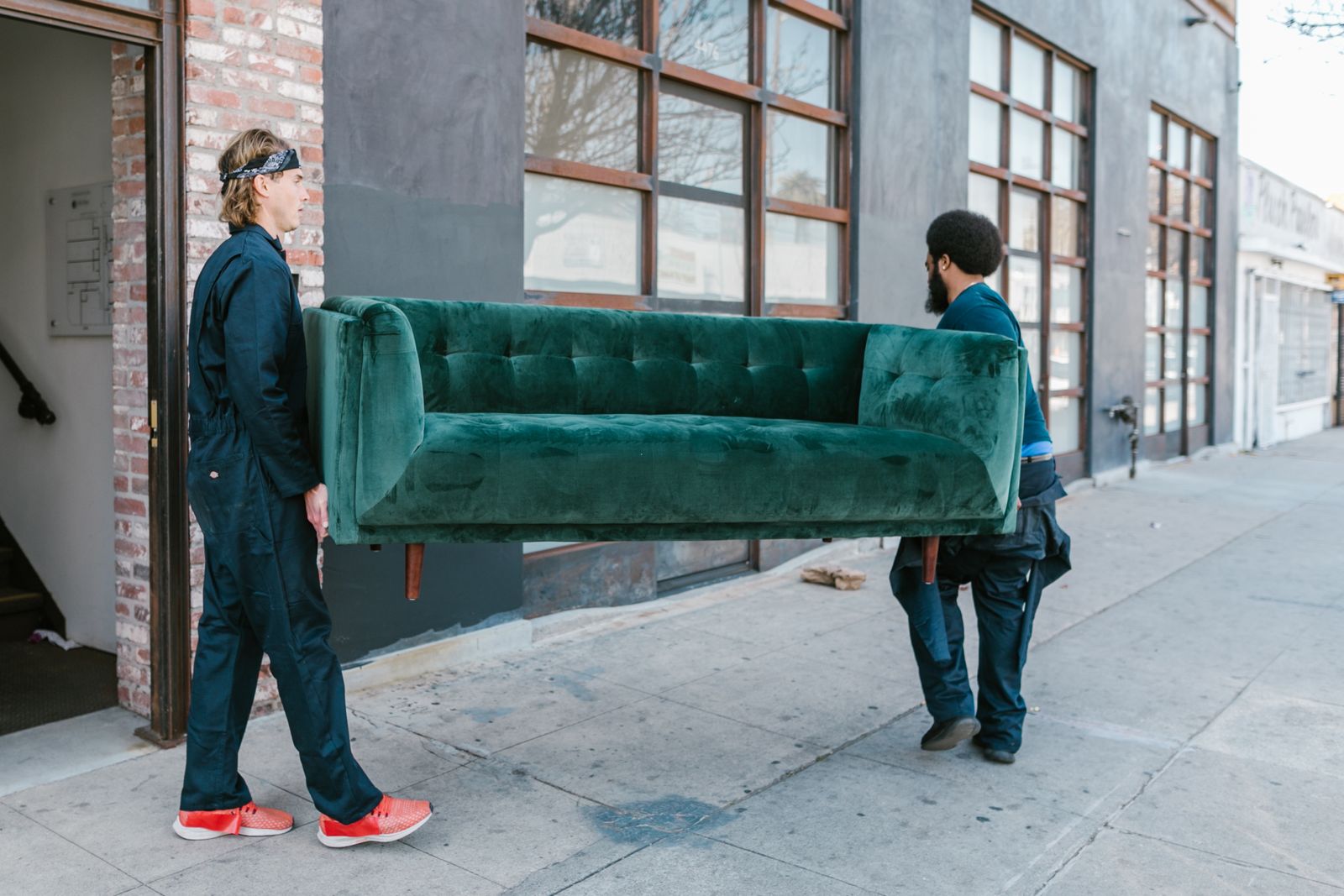 Home Junk removal crew carrying an old sofa out to the truck in Elk Grove, CA